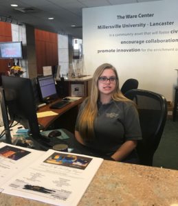 A young woman working at a desk.