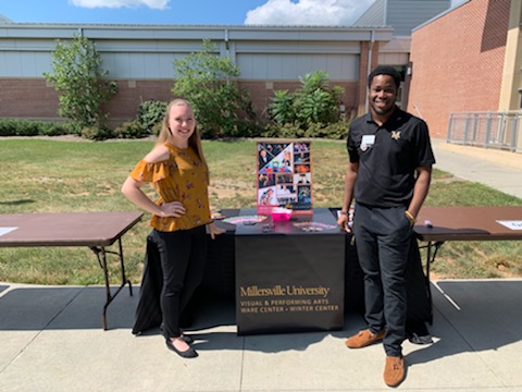 Students manning a job fair stand.