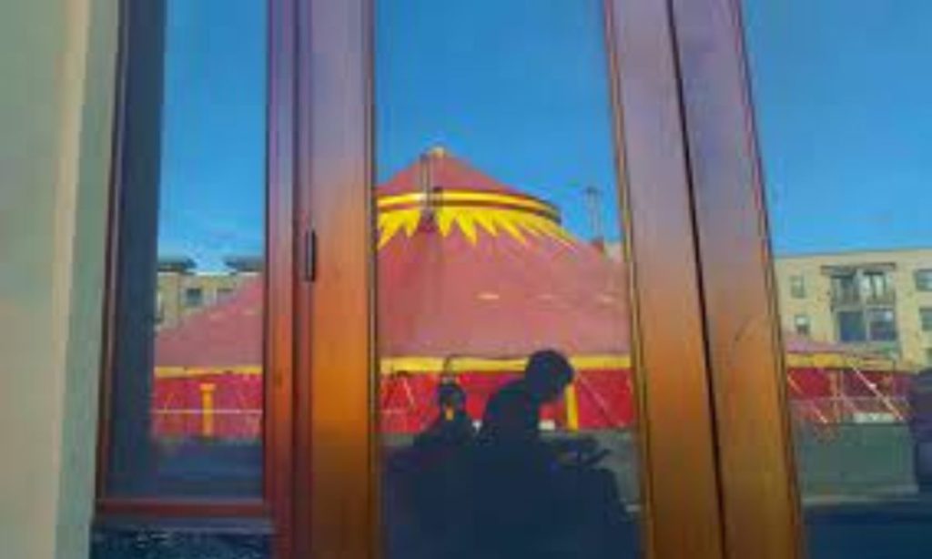 A circus tent reflected in a window.