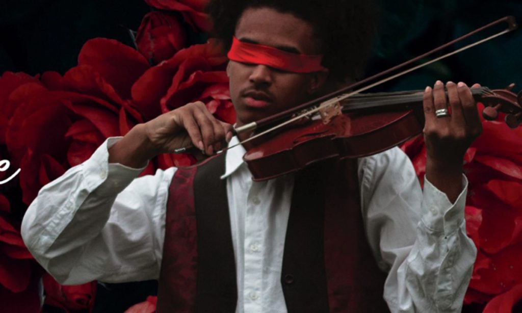 A man playing a violin while blindfolded.