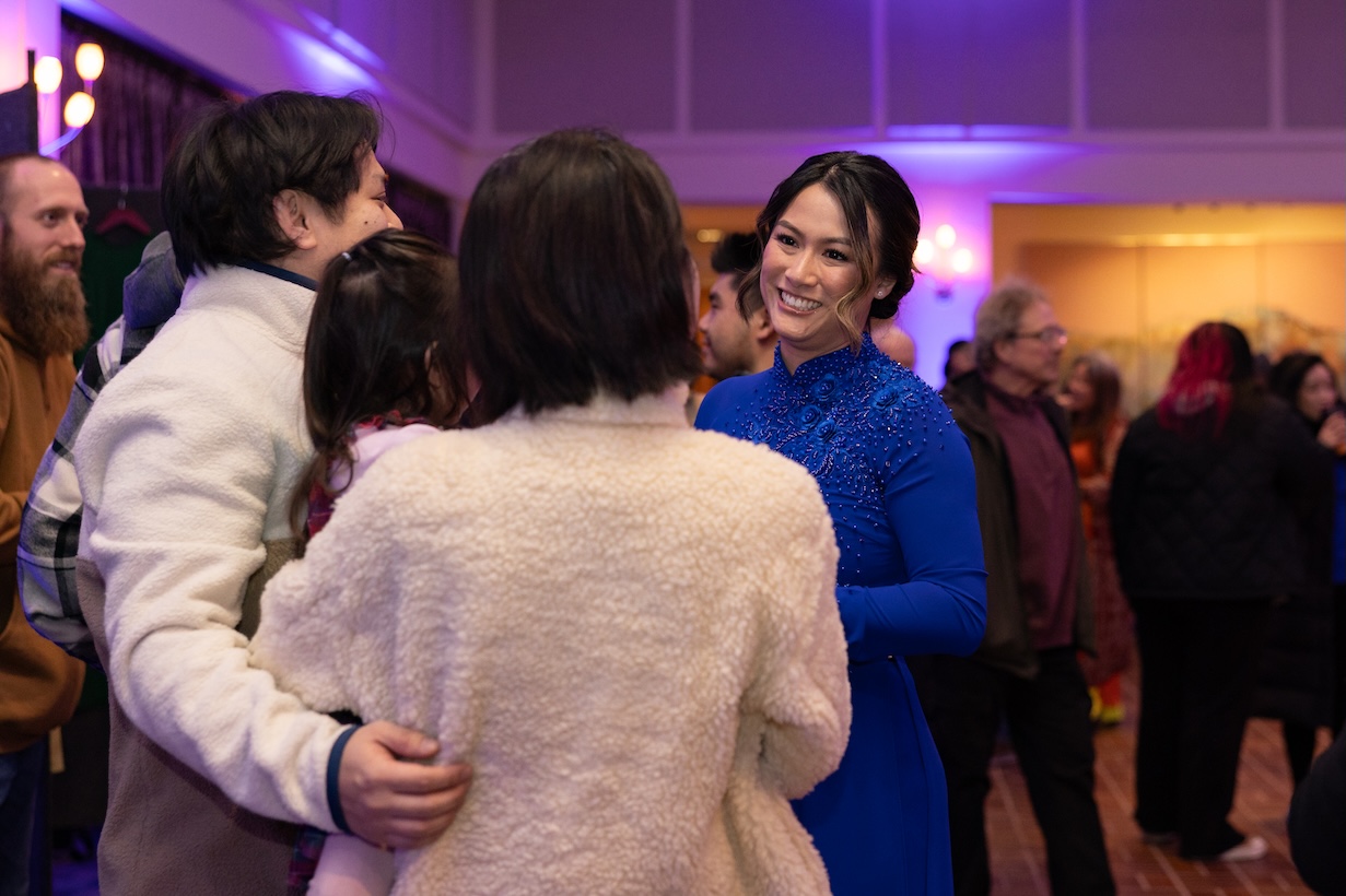 Maian McCauley speaks to friends during the Our Journeys opening event.
