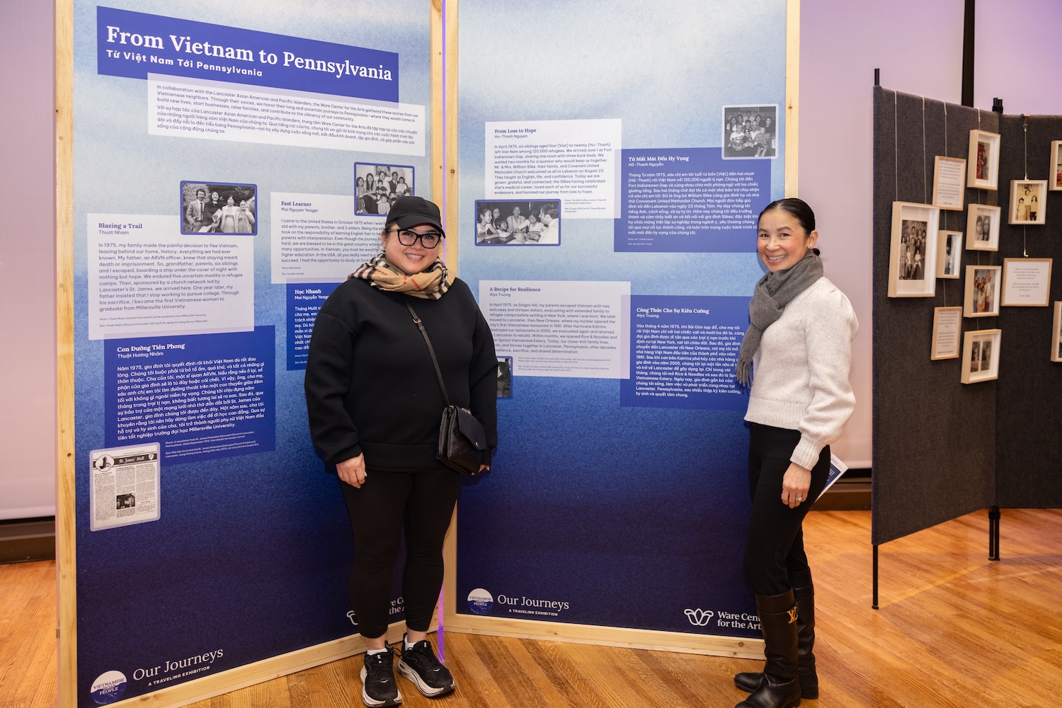 Members of the Sprout/Rice & Noodles family stand by the exhibit panel that tells their family's story