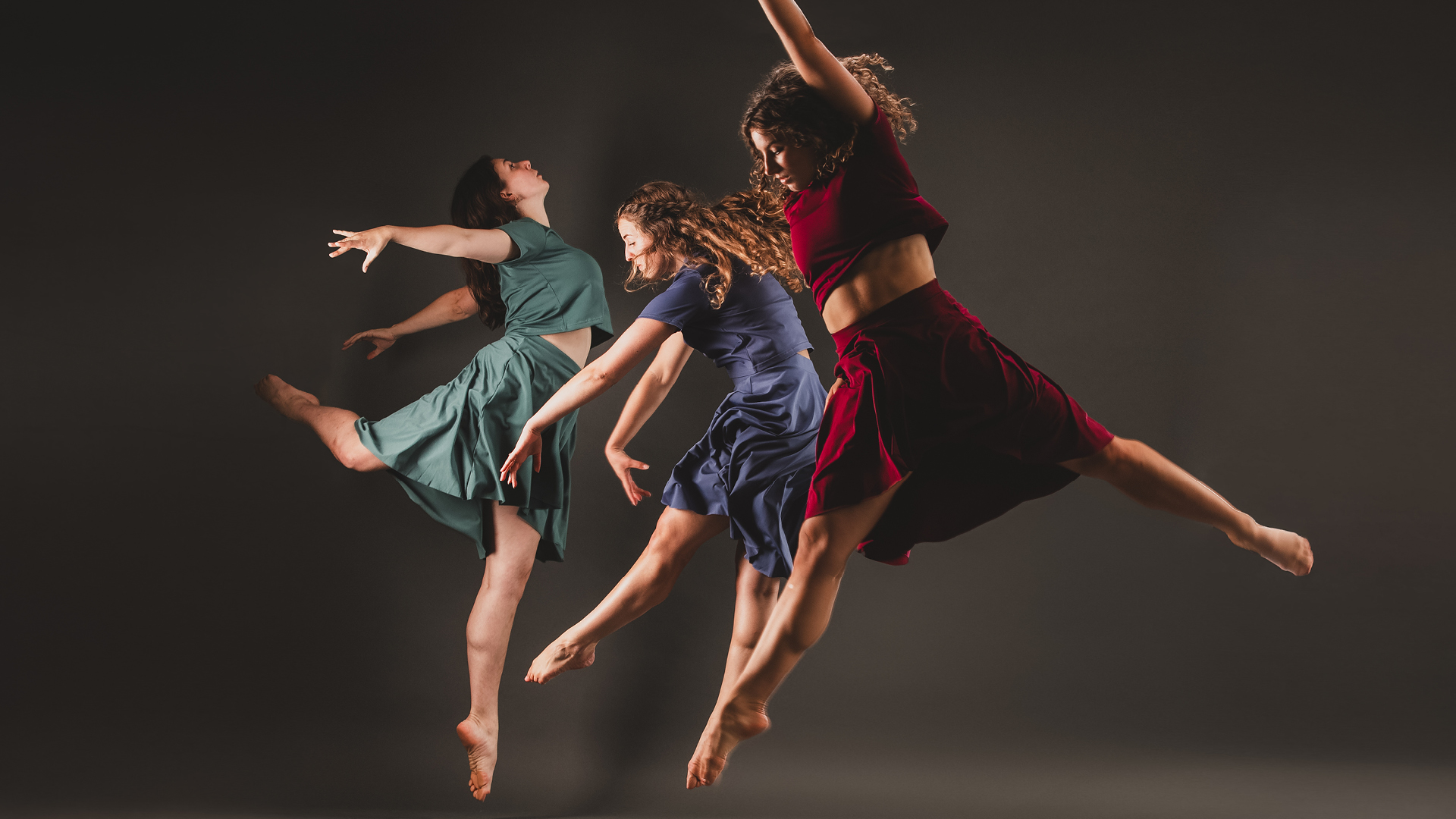 Dancers from the LUNA Dance Company jump in the air