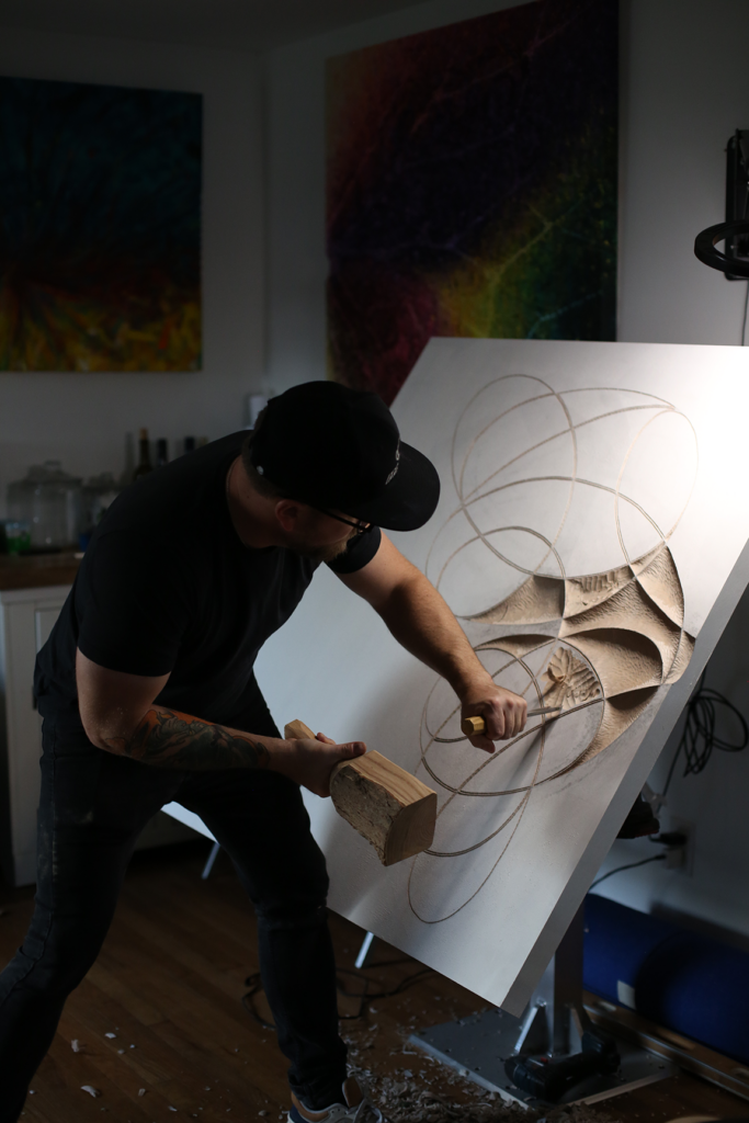 Rob Homan carves a sculpture by hand